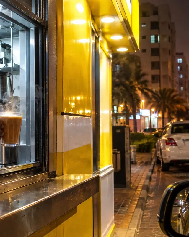 Karak handed through a cafeteria window to a car at night